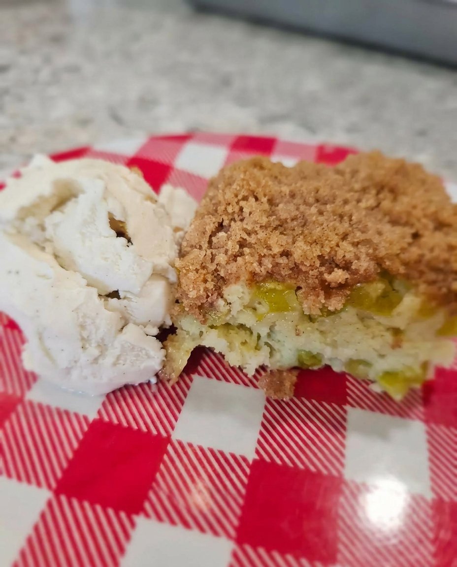 Chopped fresh rhubarb and diced strawberries on a wooden cutting board.