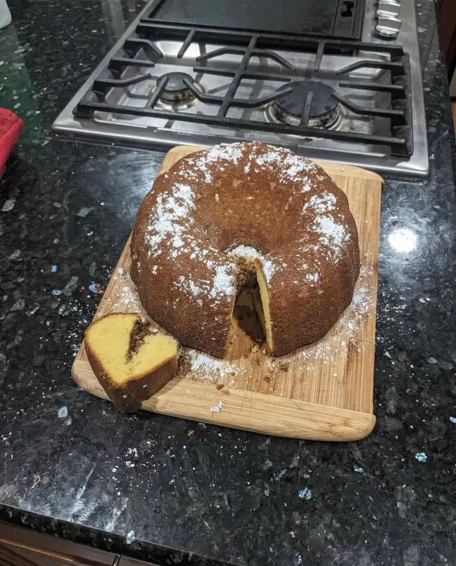 Glazed Sock It To Me cake on a white cake stand ready to be served