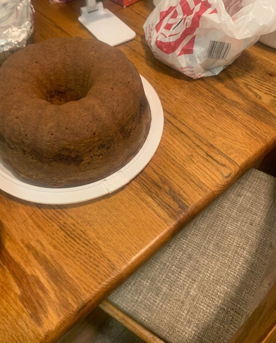 Golden brown baked bundt cake resting on a wire cooling rack