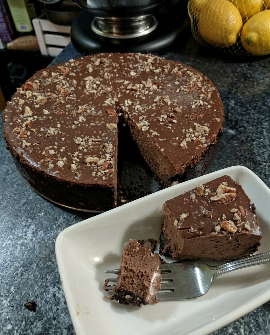 A moist dark chocolate truffle cake cooling on a wire rack in a farmhouse kitchen