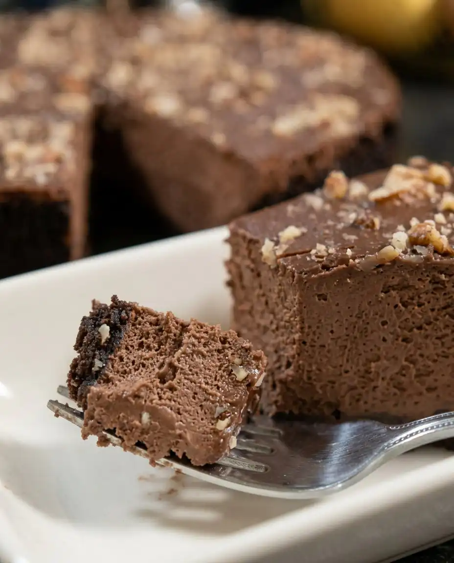 A beautiful slice of chocolate truffle cake showing the distinct cake and mousse layers