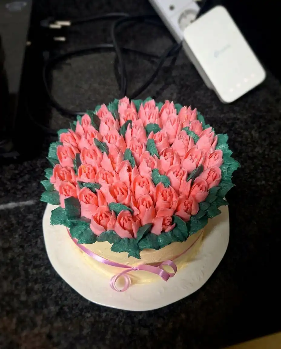 A slice of tulip cake served on a simple white plate