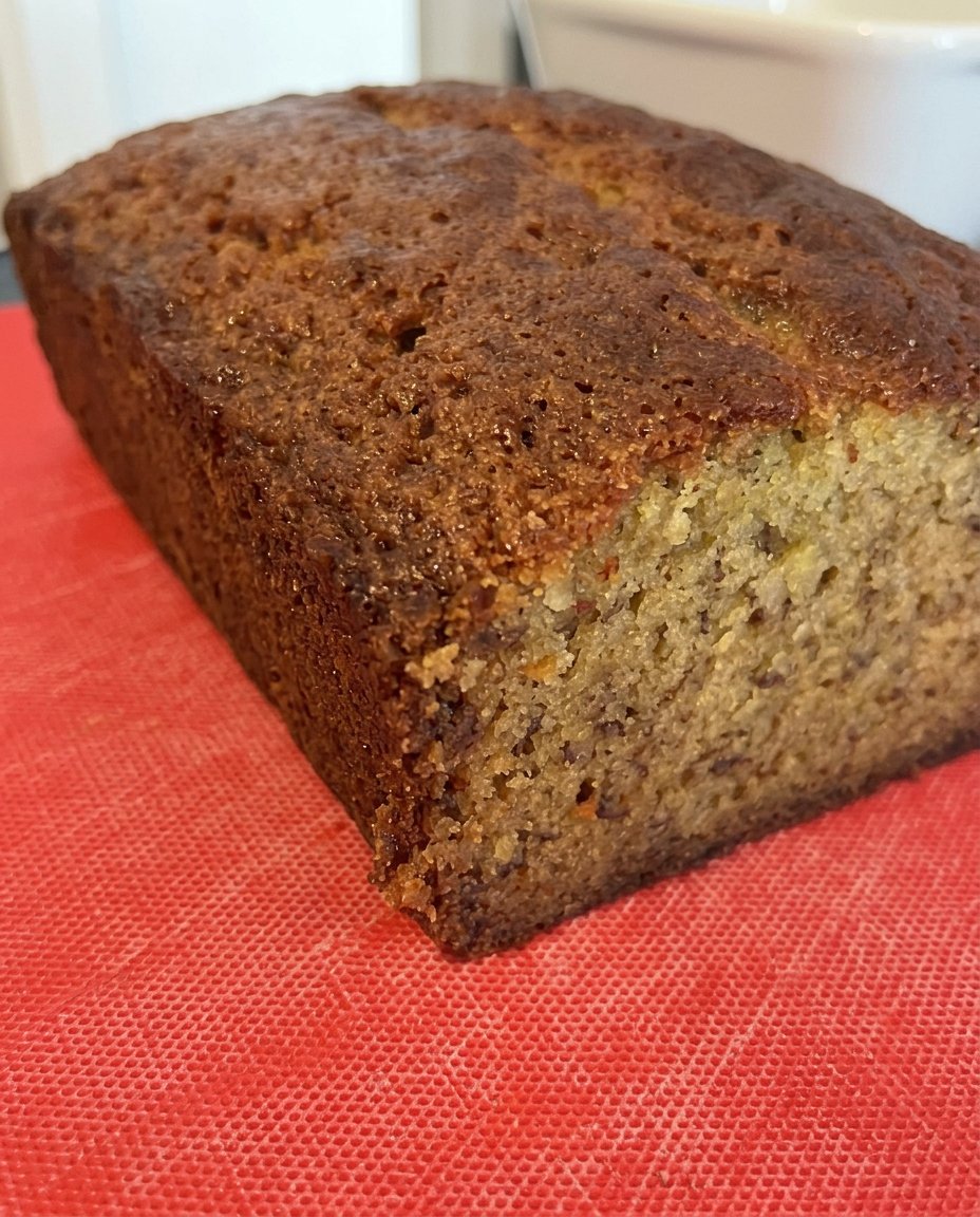 Banana Coffee Cake 14 A serrated knife slicing through the crumb topping of a banana cake