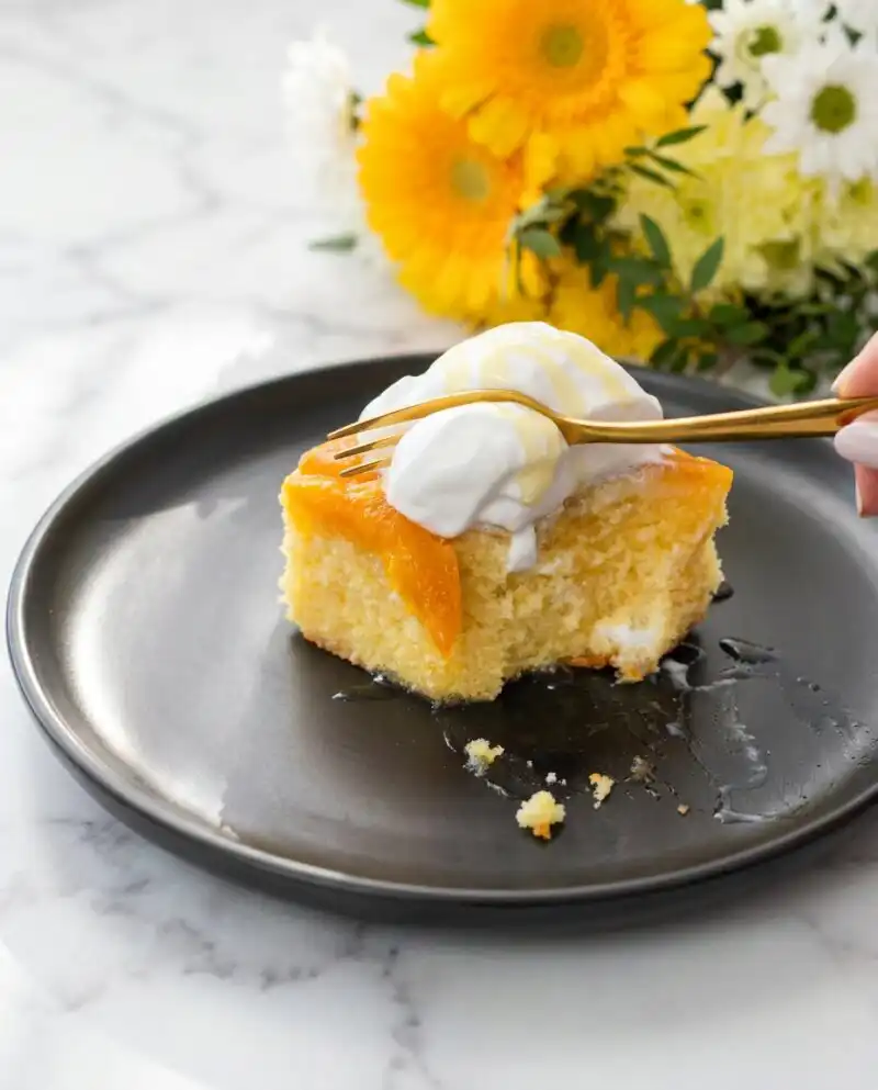 A golden Brown Sugar Peach Upside Down Cake cooling on a wire rack with caramelized fruit.