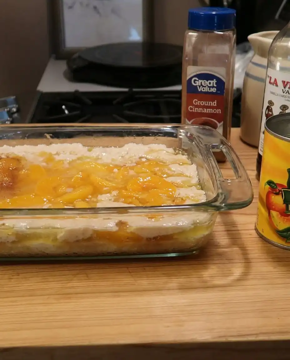 Close up of bubbling peach cobbler syrup and golden crust