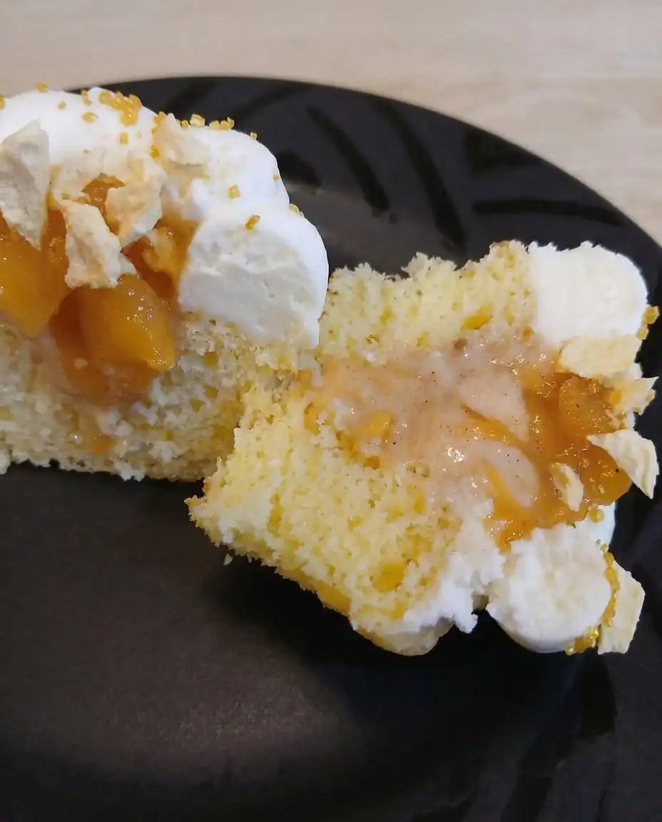 Peach & Honey Cheesecake Cupcakes 13 Smooth and creamy honey cheesecake batter being spooned into muffin liners.
