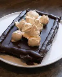 Slices of Peanut Butter Fudge Cake on a rustic farmhouse table