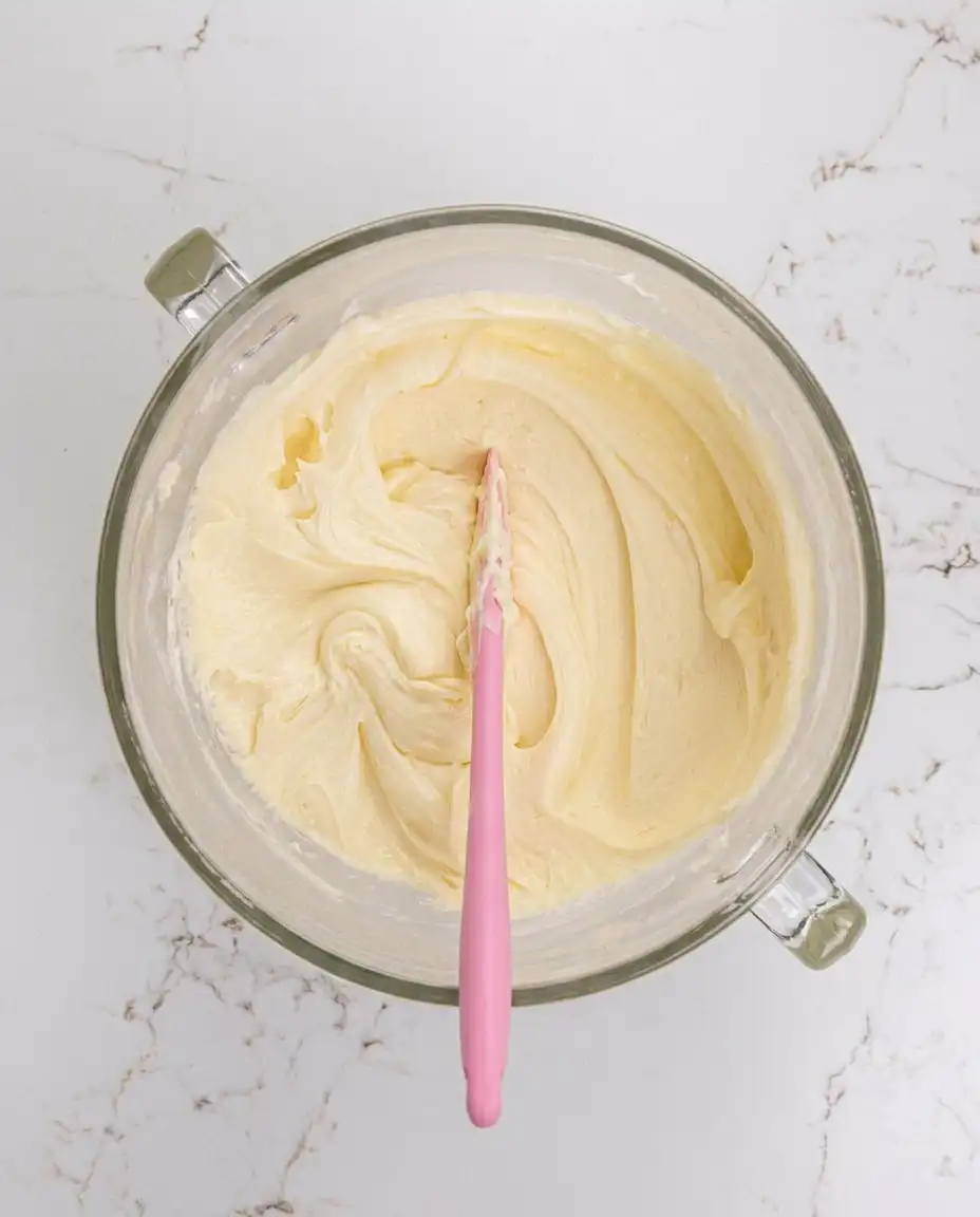 Vanilla Mousse Cake Filling 13 Hand folding whipped cream into a cream cheese base for vanilla mousse cake filling
