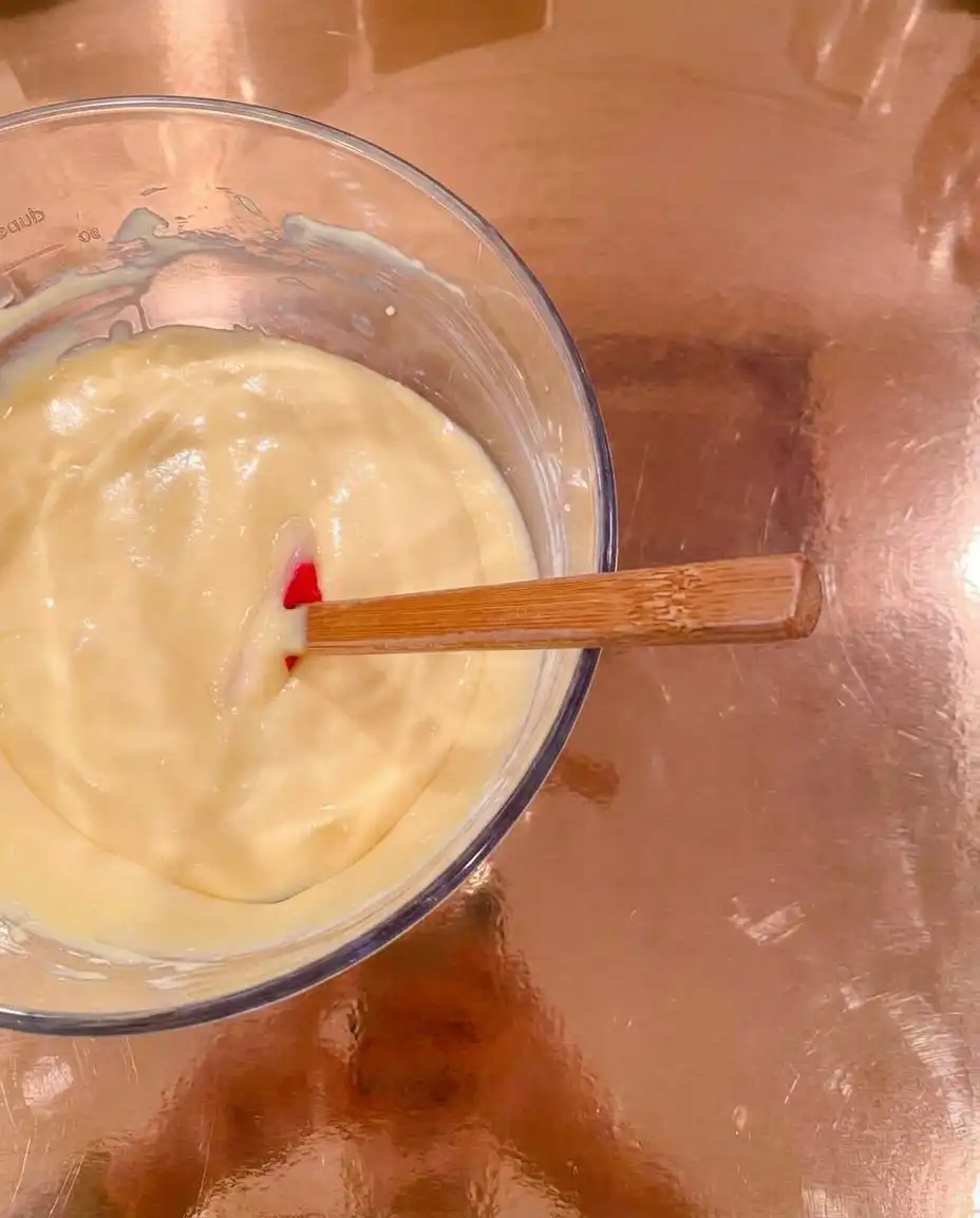 Pressed graham cracker crust in a baking pan for cheesecake bars