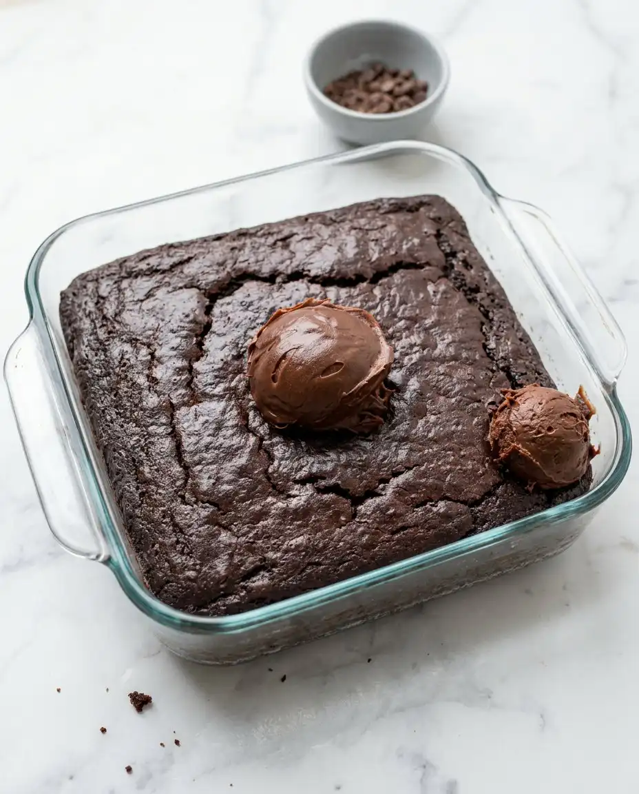 Finely grated green zucchini piled on a digital scale for the Vegan Chocolate Zucchini Cake.