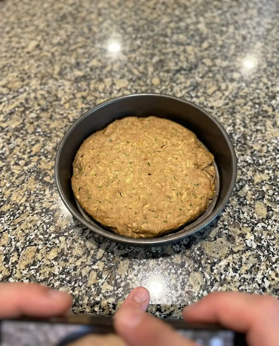 Moist Zucchini Banana Cake 13 Freshly grated green zucchini on a rustic wooden cutting board
