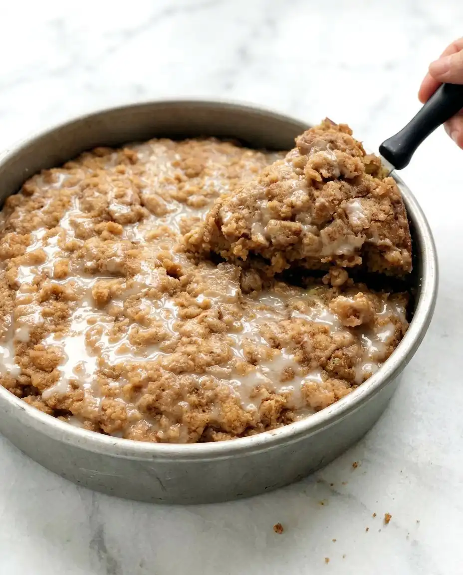 A single slice of Lemon Zucchini Coffee Cake showing the internal crumb and green zucchini flecks.