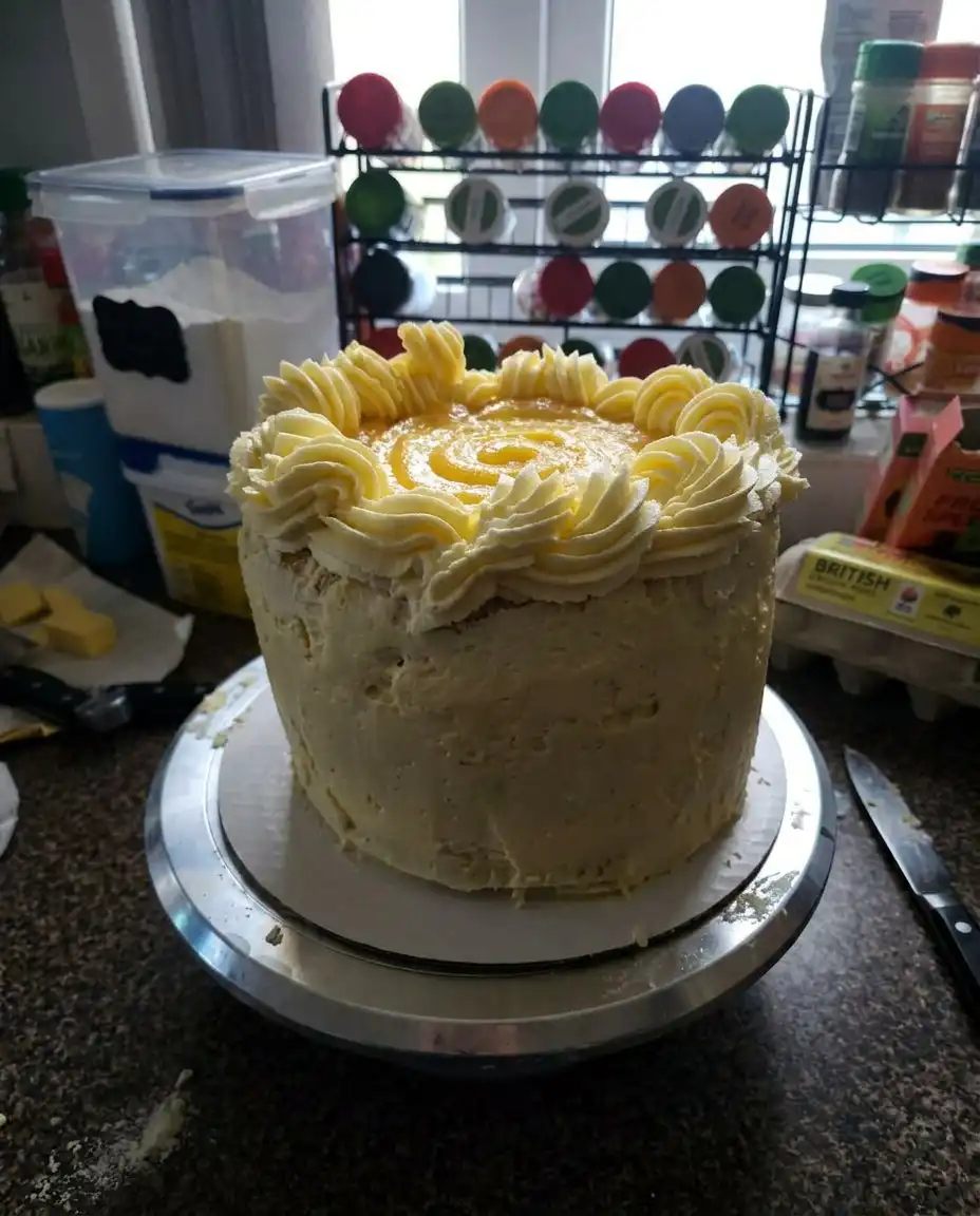 A single slice of Orange Creamsicle Cake served on a Southern floral plate.