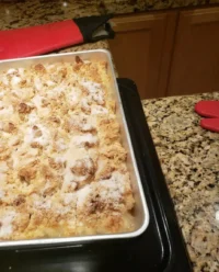 Paula Deen Peach Cobbler with a golden brown crust in a glass baking dish