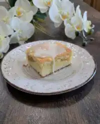 A close up view of several Peaches and Cream Bars stacked on a vintage white plate.