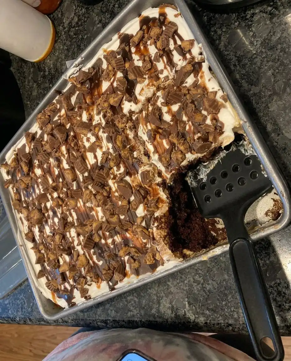 Several square slices of peanut butter poke cake on a serving platter.