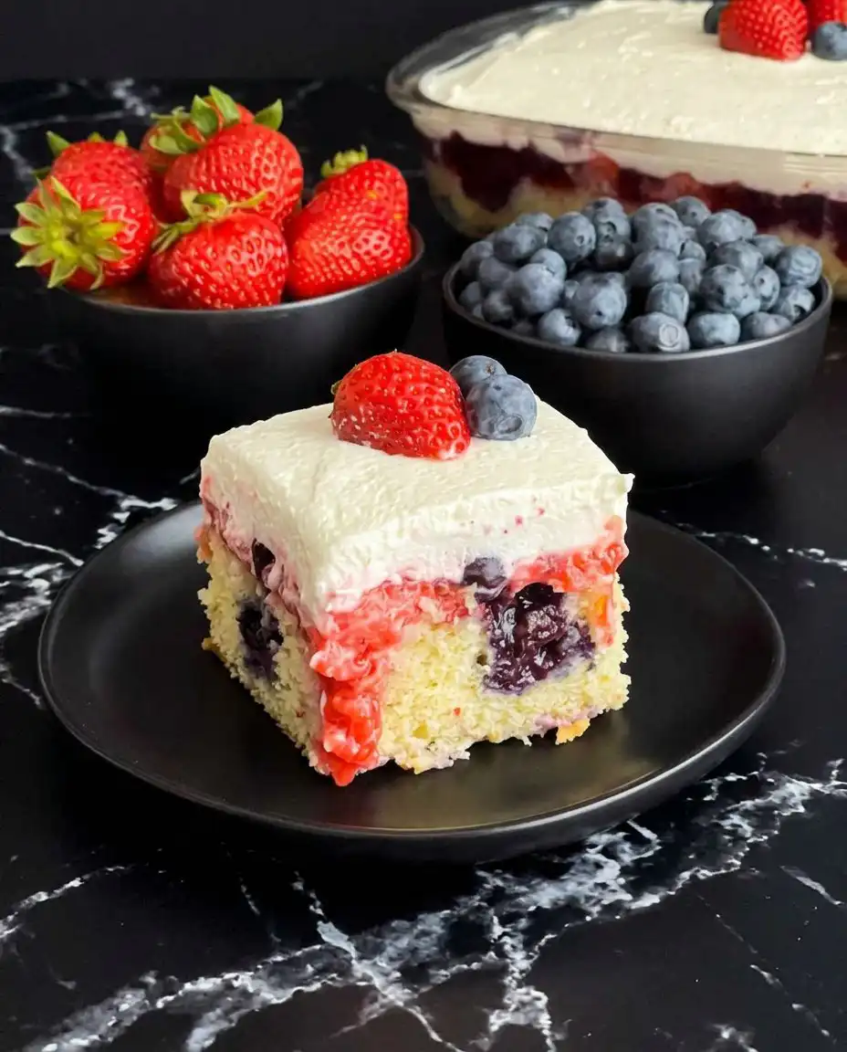 Summer Berry Poke Cake 13 A wooden spoon handle creating holes in a baked white cake