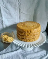 A close up side view of the layers in a Ritz Cracker Salted Caramel Icebox Cake showing the cream cheese and caramel tiers.