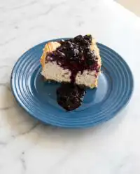 A Moist Blueberry Lemon Angel Food Cake showing its rustic crackled top and golden edges.