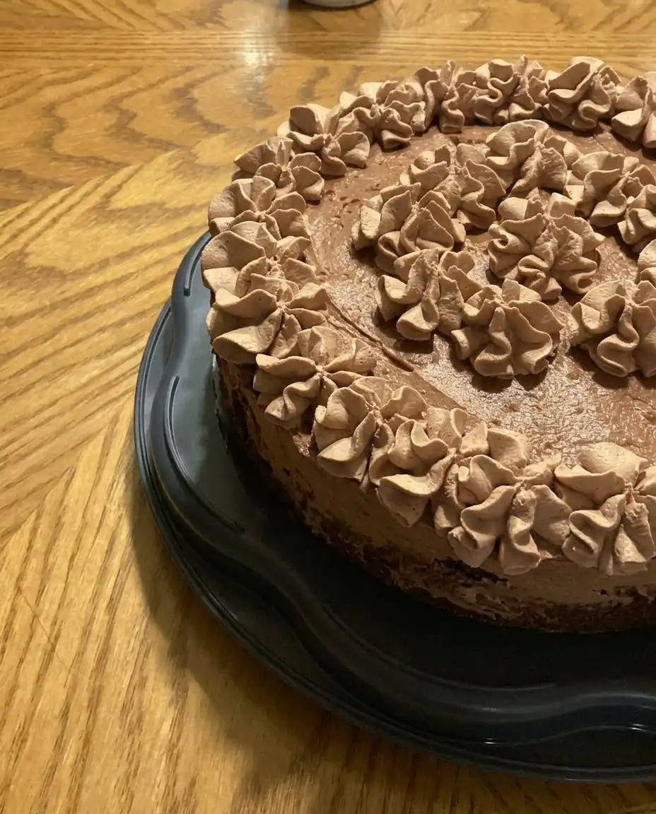 Chocolate Mousse Cake 10 A rustic Chocolate Mousse Cake topped with fresh chocolate whipped cream on a farmhouse table.