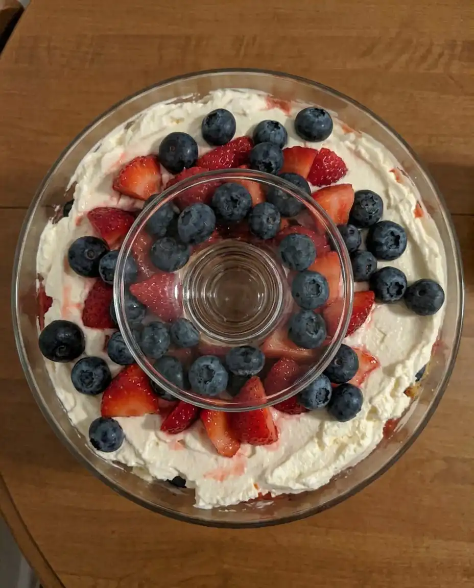 4th of July Trifle 14 A generous scoop of layered berry dessert served on a white vintage plate with a silver spoon.