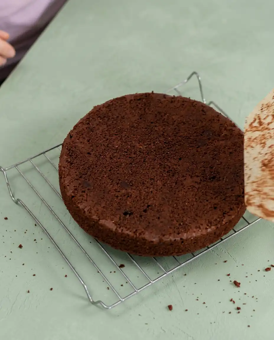 A thick slice of Zucchini Cake with pecans served on a vintage china plate.