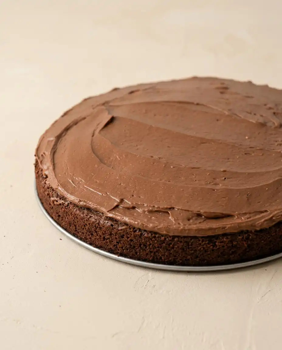 A full loaf of Sugar-Free Chocolate Zucchini Cake on a wire cooling rack.