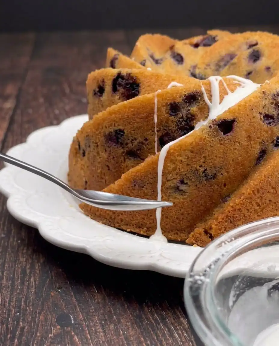 Cherry Amaretto Bundt Cake 13 Fine cake flour being sifted into a ceramic mixing bowl.