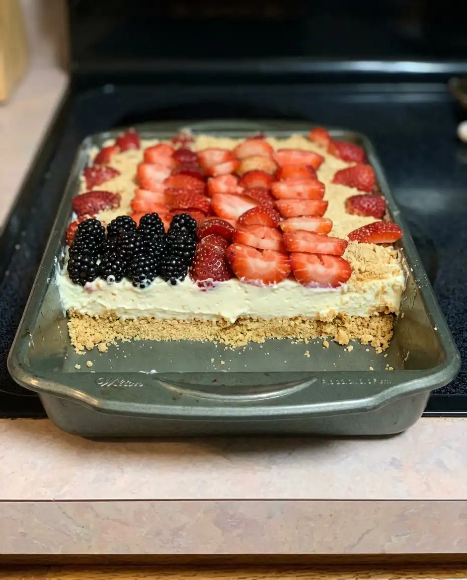 A single square slice of the berry yum yum showing all the distinct patriotic layers.