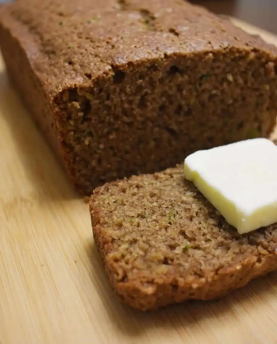 Two thick slices of apple zucchini bread showing the moist crumb and fruit pieces.