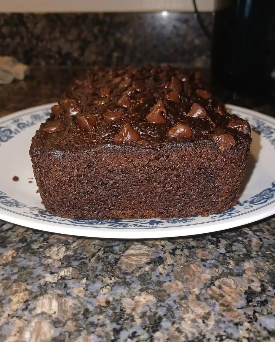 Slices of chocolate zucchini bread served with a pat of butter