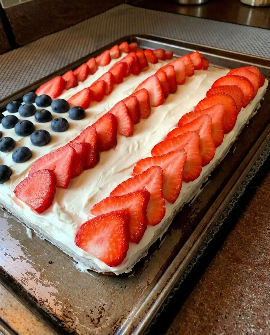 A slice of gluten free American flag cake on a plate with ice cream