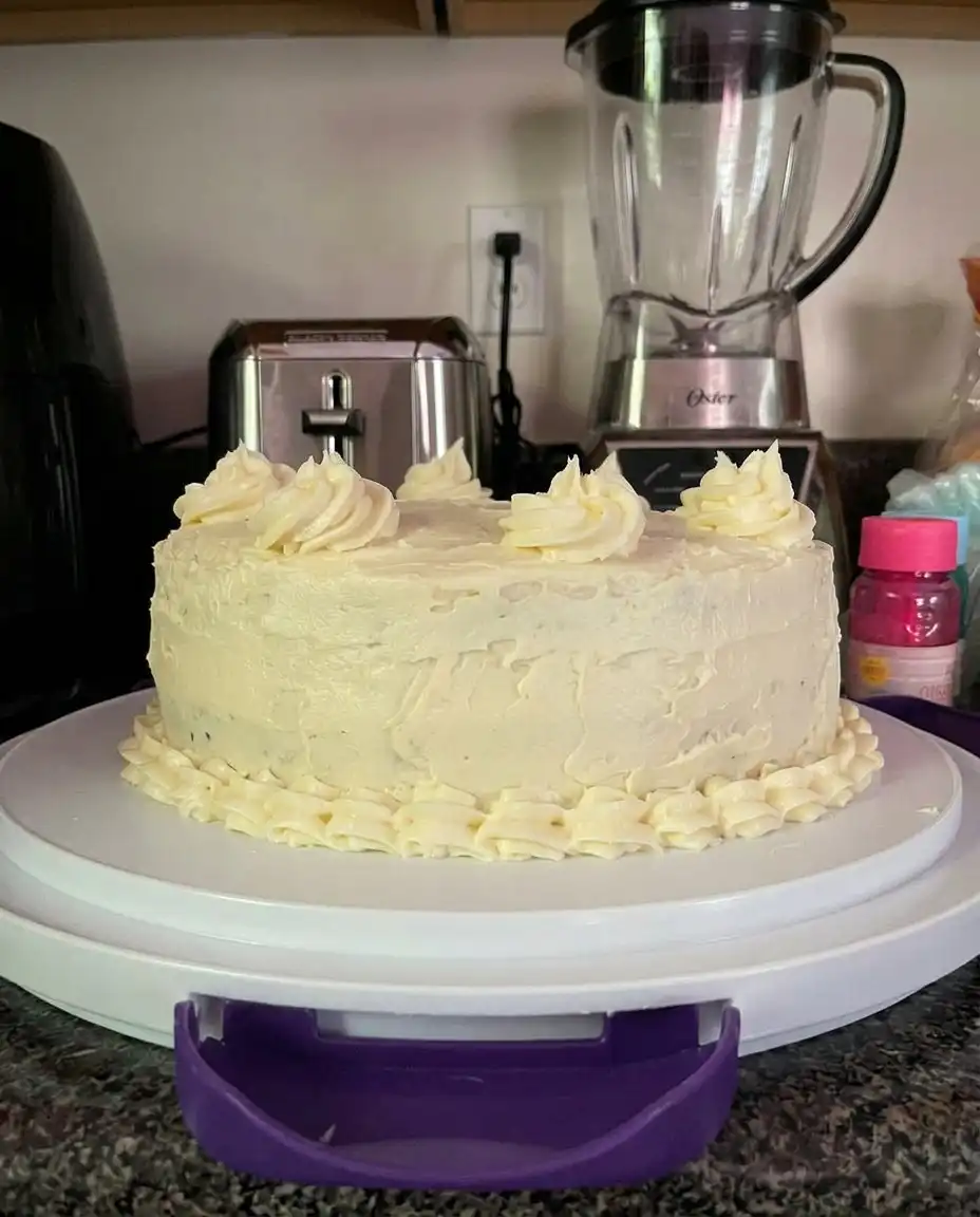 A slice of lemon velvet cake showing the tight tender crumb