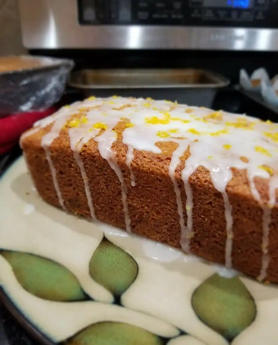 Slices of lemon zucchini bread on a white plate with a linen napkin