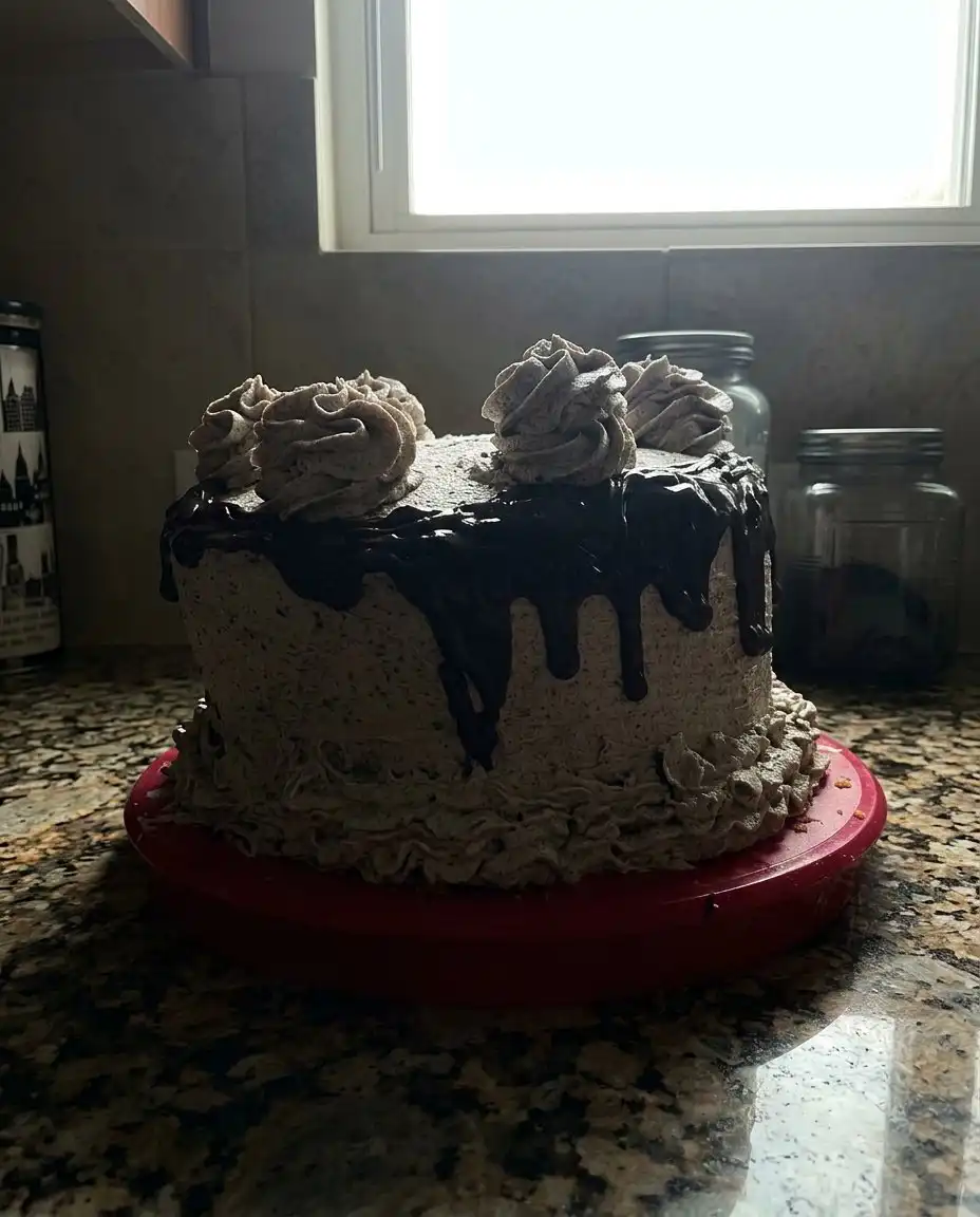 The Softest Oreo (Cookies & Cream) Cake 14 A slice of Oreo cake showing the soft interior layers and cookie chunks.
