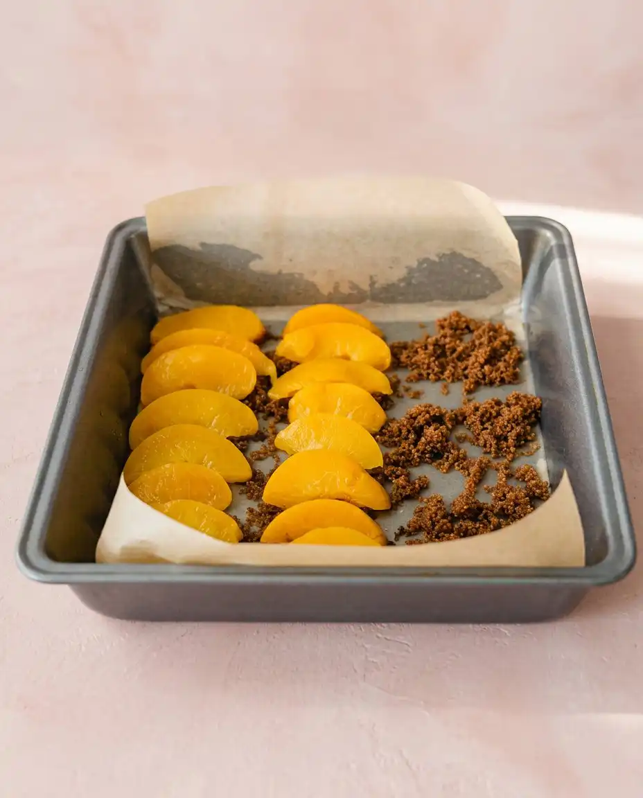 A toothpick testing the center of a Brown Sugar Peach Upside Down Cake for doneness.