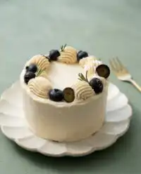 A rustic Three-Layer Earl Grey Cake resting on a wire cooling rack on a wooden counter.