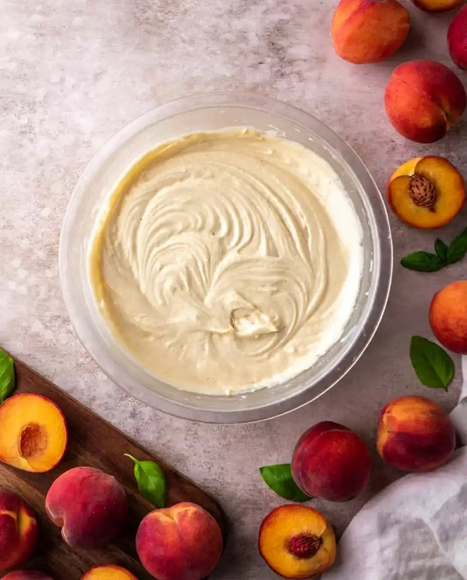 Whipped cream with vanilla bean specks in a cold metal bowl.