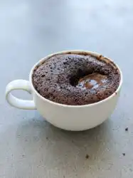 A close up view of a Chocolate Lava Mug Cake showing the rich molten center and tender crumb.