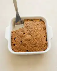 Freshly baked Classic Blueberry Coffee Cake with golden cinnamon streusel in a ceramic baking dish.