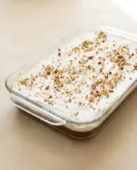 A slice of Classic Pumpkin Crunch Cake showing the clear custard and pecan layers