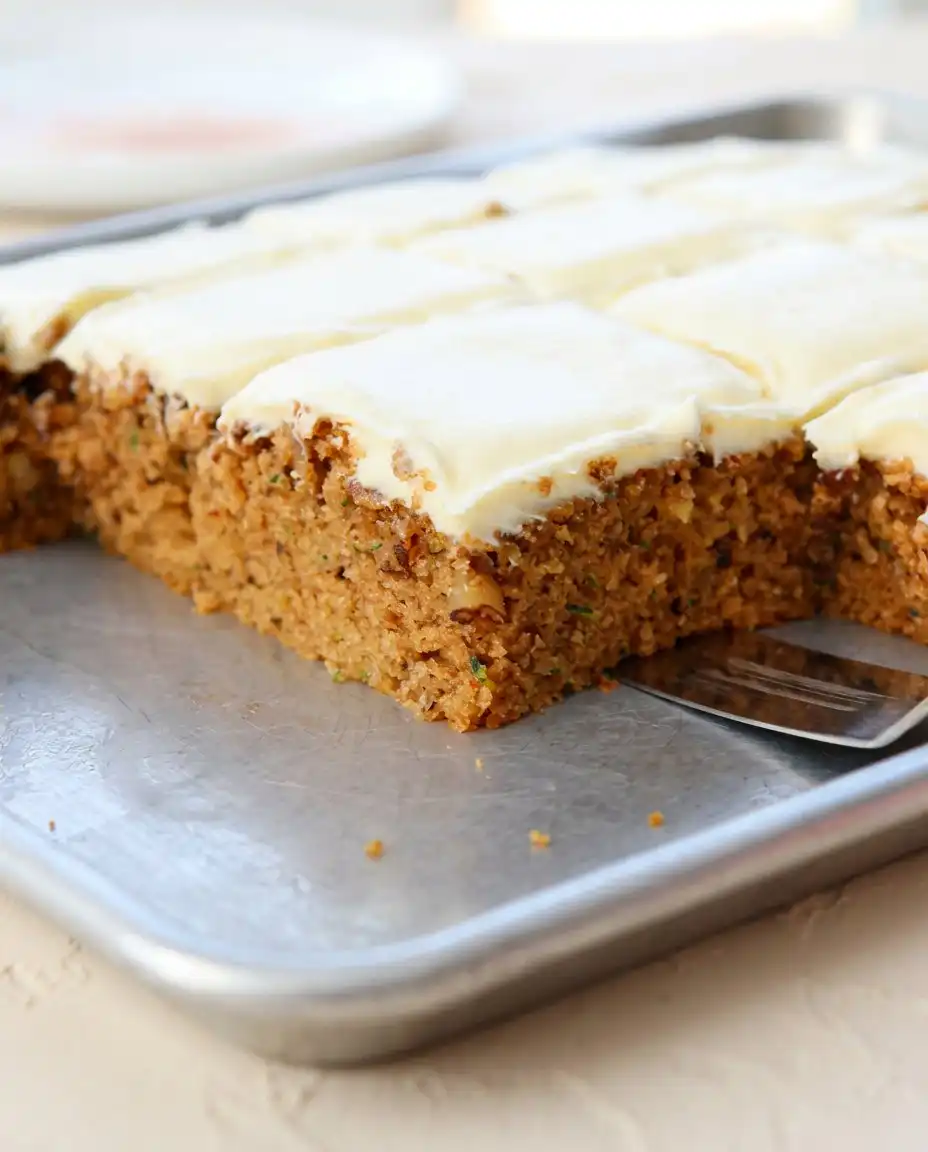Zucchini Spice Cake 12 A freshly baked moist Zucchini Spice Cake resting on a wire rack inside a rustic kitchen