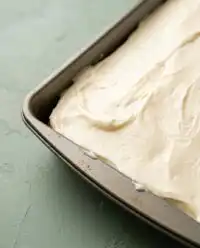 Freshly baked Pumpkin Spice Cake in a metal pan cooling on a wire rack.