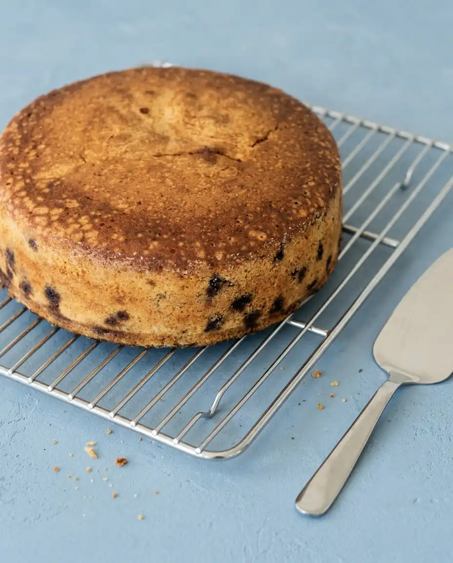 A perfect slice of Blueberry Lemon Olive Oil Cake served with a glass of sweet tea.